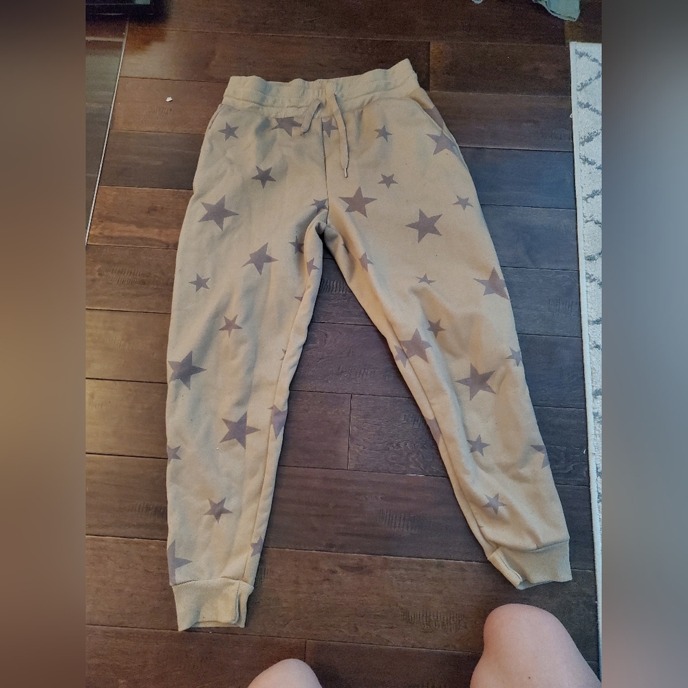 Joggers size large women's by If It Were Me brand cream with stars on it.